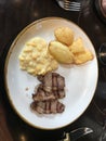 Sliced picanha with corn cream and potato soufle Royalty Free Stock Photo